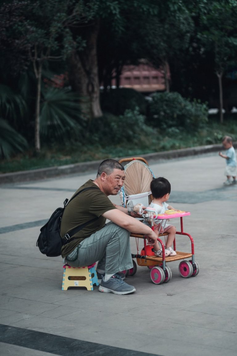 man and woman riding red and yellow trike